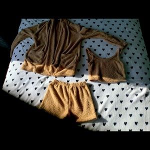 Set that has fluffy cozy jacket, shirt cropped, and shorts.